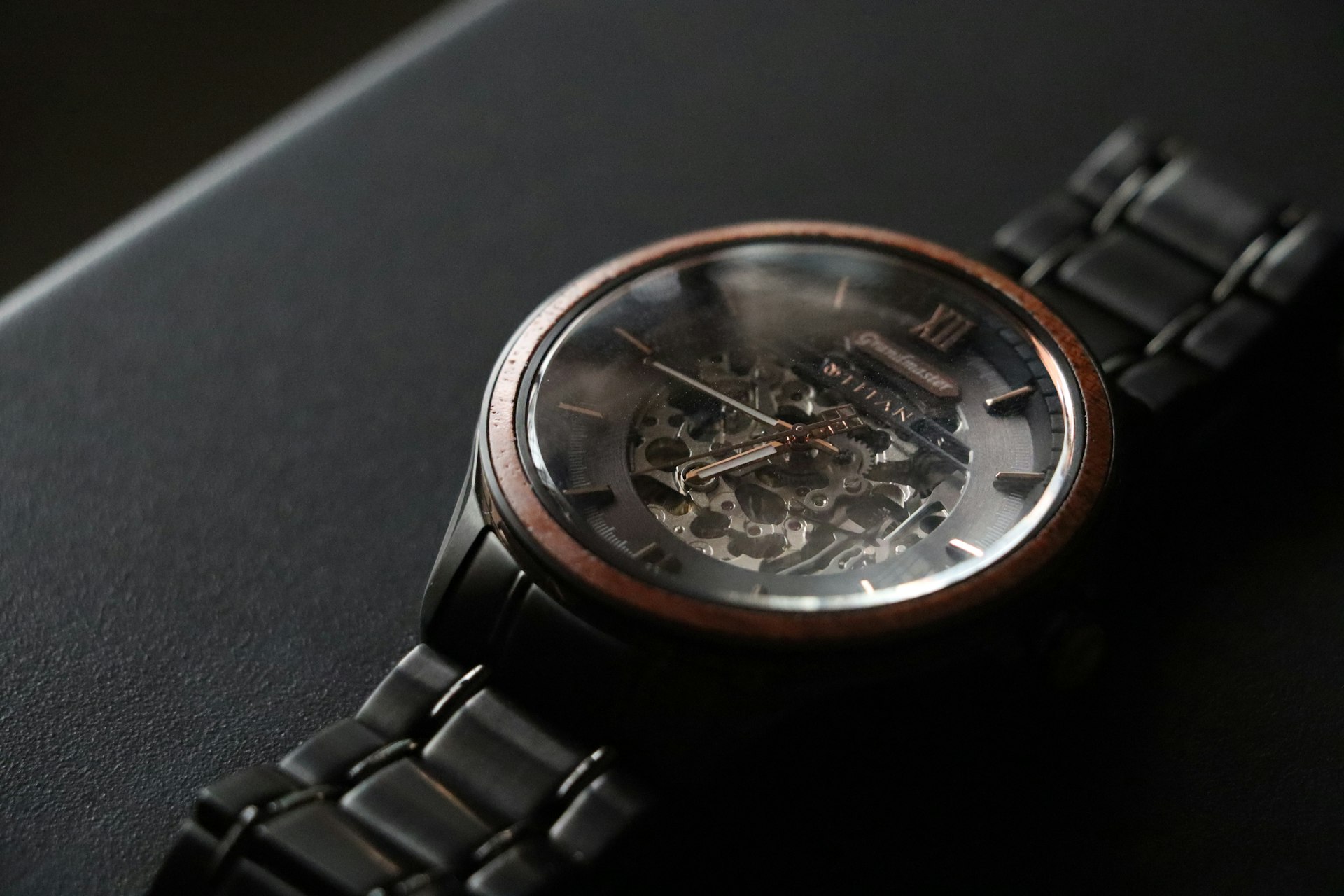 Luxury chronograph watch on dark surface, macro studio photography, ultra-detailed